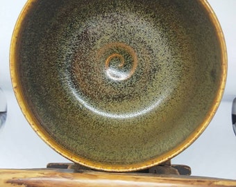 Vintage Japanese hand-made stoneware glazed tea bowl, chawan, "the memory of tea". Brown green glaze.  Cream stoneware body. Signed
