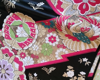 Black and gold vintage Japanese Fukuro formal obi for kimono. Woven pattern of geometric floral design in vibrant red, purple and metallic.