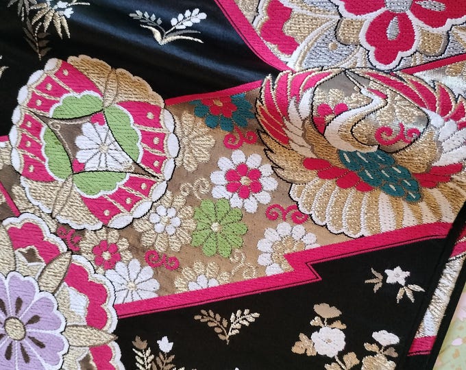 Black and gold vintage Japanese Fukuro formal obi for kimono. Woven pattern of geometric floral design in vibrant red, purple and metallic.