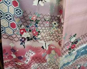 Vintage pink Japanese handsewn soft silk kimono with a pattern cranes and treasures. Colourful and playful.