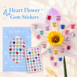 May include: A light blue box and a sheet of heart-shaped gem stickers in various colors, with the text "Heart Flower + Gem Stickers" and "LUTOY C". A flower with heart-shaped gems is also shown.