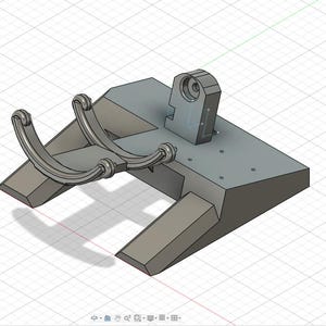 Puede incluir: Un componente mecánico gris modelado en 3D con una base rectangular y brazos curvos. Una estructura cilíndrica se eleva desde la base, y el diseño incluye varios pequeños detalles circulares. El objeto se representa en una cuadrícula.