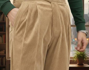 May include: Tan corduroy pants with a high waist and pleated front. The pants have a wide waistband and pockets. The person is wearing a green long-sleeve shirt. The pants are a neutral color, suitable for various outfits.