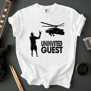 May include: A white ceramic mug with a black handle and the text "But First, Coffee" in a black, handwritten-style font. The mug is on a white surface.