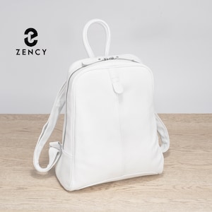 May include: A white leather backpack with a top handle and adjustable shoulder straps. The backpack has a zippered main compartment and a small front pocket. The brand name "ZENCY" is printed in black on the upper left corner.