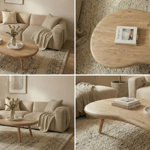 May include: A light wood coffee table with an irregular, organic kidney-bean shape and four tapered legs. The surface features a natural wood grain pattern and holds a stack of books, a small vase with dried foliage, and a round tray.