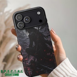 May include: Black phone case featuring a dark, detailed illustration of a figure in a cloak, with red accents. The case has a black camera module and the text "S.P.E.C.I.A.L CREATIONS" in green.