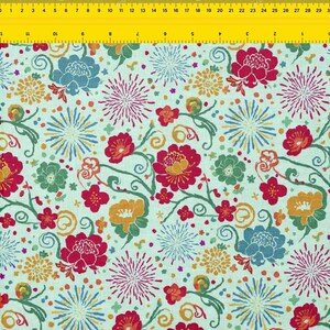 May include: A fabric with a repeating floral pattern. The design features large red, blue, and yellow flowers, along with smaller green and orange blossoms, set against a light green background. The pattern includes stylized fireworks and swirling vines.