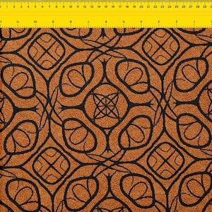 May include: Close-up of a fabric with a repeating pattern. The design features black, curved lines forming shapes on a textured, orange-brown background. The pattern includes circular and square elements.
