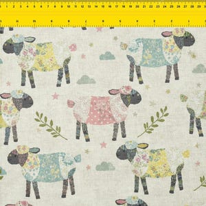 May include: A fabric with a repeating pattern of sheep. The sheep are in various colors, including yellow, blue, and pink, with floral and polka dot patterns. The background is a light beige color, with small stars and cloud shapes.