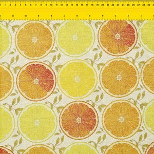 May include: A fabric pattern featuring large, circular slices of oranges and lemons in shades of yellow, orange, and red. The citrus fruit slices are arranged in a repeating pattern with small, leafy sprigs on a cream-colored background.