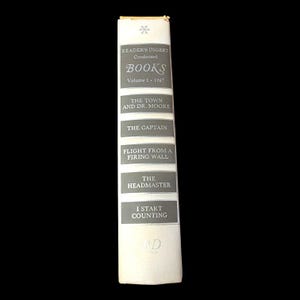 May include: A vintage Reader's Digest Condensed Books volume. The spine is white with gray text, including the title "BOOKS" and the year "1967." The book titles are listed: "THE TOWN AND DR. MOORE," "THE CAPTAIN," "FLIGHT FROM A FIRING WALL," "THE HEADMASTER," and "I START COUNTING."