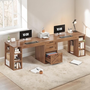 May include: A large, brown wooden desk with multiple sections, drawers, and open shelving. Two computer monitors display "10 08". The desk has a printer, desk lamp, and various office supplies. The desk sits on a light-colored rug.