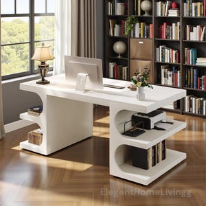 May include: A modern white desk with curved supports and built-in shelves. The desk features a computer monitor, printer, and decorative items. The desk is in a home office setting with a bookshelf and window in the background.