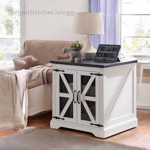 May include: A white and black side table with a farmhouse design. The table has two doors with a mesh design and black hardware. A tablet rests on the black tabletop, and a lamp and decorative zebra are also on top.