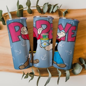 May include: Three stainless steel tumblers featuring the cartoon character Popeye. Each tumbler has a light blue background with white anchor icons and the word "POPEYE" in pink. Popeye is depicted in various poses on each tumbler.