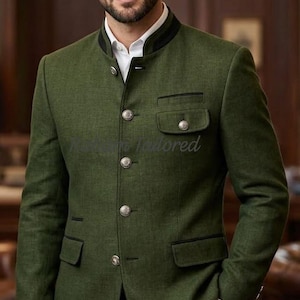 May include: A green blazer with a black trim and silver buttons. The blazer has a mandarin collar and two front pockets. The person is wearing a white dress shirt and dark gray pants.