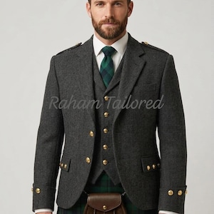 May include: A charcoal grey herringbone tweed jacket and matching waistcoat with gold buttons, a white collared shirt, a green and navy plaid necktie, a green and navy plaid kilt, and a brown leather sporran with three tassels. Text reads Raham Tailored.