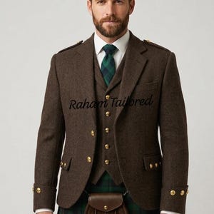 May include: A brown herringbone tweed jacket and waistcoat set featuring gold-tone buttons, a white collared shirt, a green and blue plaid necktie, and a matching plaid kilt with a brown leather sporran. The text Raham Tailored is visible.