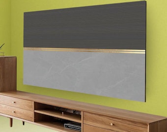 May include: A modern wall panel with a two-tone design. The top section is dark gray with horizontal lines, while the bottom is light gray with a marble-like pattern. A thin gold stripe separates the two sections. The panel is mounted above a wooden entertainment center.