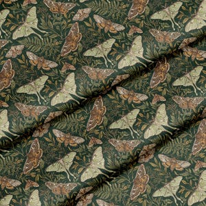 May include: Dark green fabric with a repeating pattern of moths and foliage. The moths are in shades of brown and green, with detailed wing patterns. The foliage includes ferns and other plants, creating a natural, botanical theme.