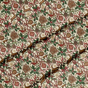 May include: A patterned fabric with a Christmas theme. The design features brown reindeer, gingerbread houses, baubles, nutcrackers, and holly leaves, set against a cream background with red and green accents.