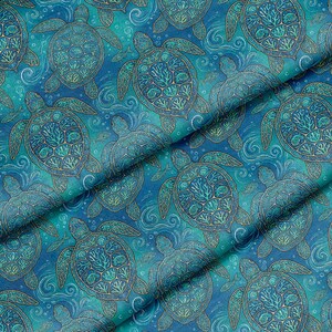 May include: A fabric with a repeating pattern of sea turtles in shades of blue and teal. The turtles have detailed shell designs and are surrounded by swirling water and small fish. The overall design has a nautical theme.