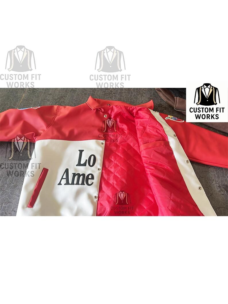 May include: A red and white jacket with the text "Lo Ame" on the front. The jacket has a quilted red interior and white stripes along the sleeves. The jacket has the text "CUSTOM FIT WORKS" on it.