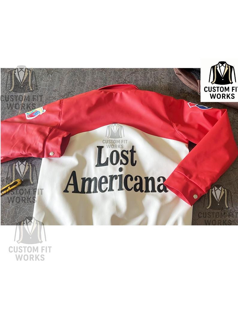 May include: A red and white jacket with the text "Lost Americana" in black. The jacket has red sleeves and shoulders, with a white body. The sleeves have buttoned cuffs. The jacket is from Custom Fit Works.