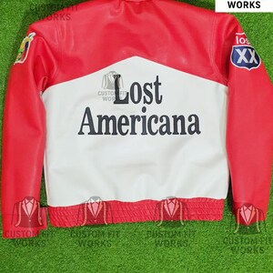 May include: Red, white, and black leather jacket with the text "Lost Americana" on the back. The jacket has a red collar, shoulders, and sleeves, with a white center panel. Patches are visible on the sleeves. The jacket is a custom fit.