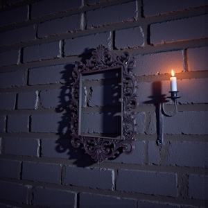 Ornate gothic baroque photo frame with intricate scrollwork and rectangular shape, styled as dramatic dark wall decor.