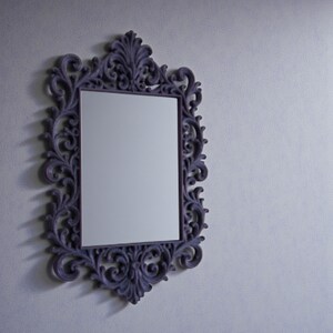 Ornate gothic baroque photo frame with intricate scrollwork and rectangular shape, styled as dramatic dark wall decor.