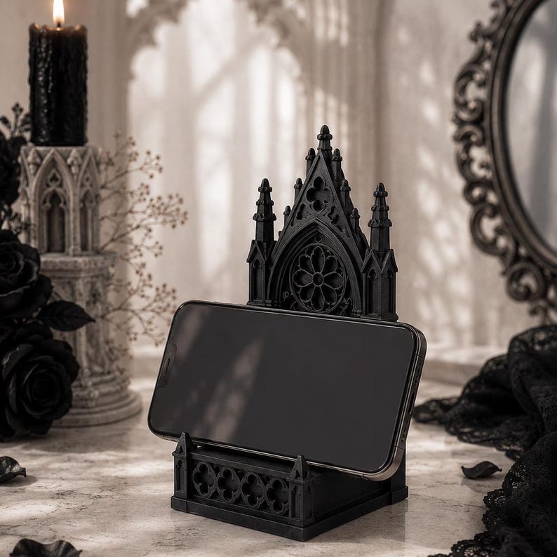 Black Gothic Cathedral phone stand displayed on a modern desk holding a smartphone.
Side view of Gothic Cathedral phone holder showing detailed medieval window design.
Front view of cathedral-inspired smartphone stand with gothic architectural details.