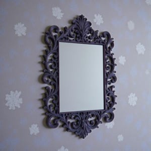 Ornate gothic baroque photo frame with intricate scrollwork and rectangular shape, styled as dramatic dark wall decor.