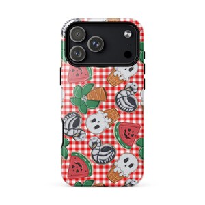 May include: A smartphone case featuring a red and white checkered pattern background with a repeating print of skull-themed ice cream cones, watermelon slices, green palm trees, and skeleton flamingo pool floats scattered across the surface.