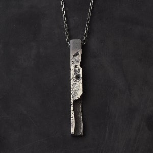 Brutalist bar necklace in sterling silver with lots of texture on a silver faceted anchor chain.