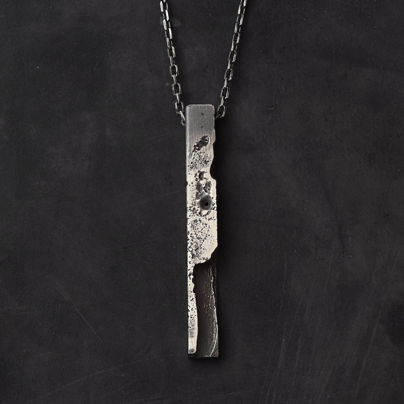 Brutalist bar necklace in sterling silver with lots of texture on a silver faceted anchor chain.