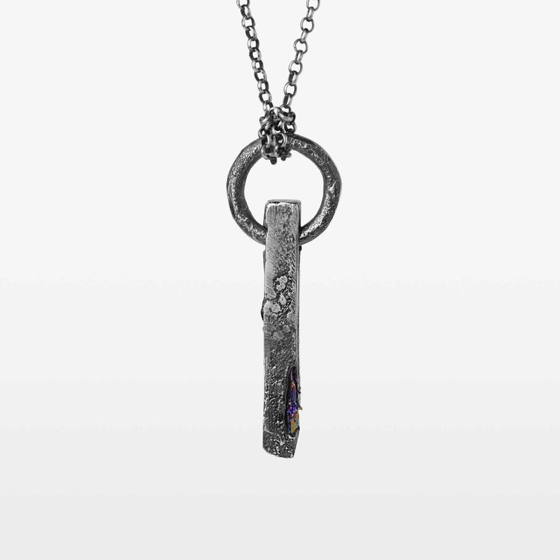 Textured bar pendant with a black stone.