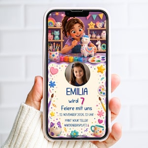 May include: A smartphone displays a colorful invitation for a child's birthday party. The invitation features a cartoon illustration of a girl painting a llama, with the text "EMILIA wird 7 Feiere mit uns" and the date and time of the party.