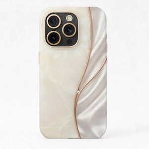 May include: A pearlescent phone case with a gold camera ring and a decorative gold swirl design. The case has a smooth, glossy finish and a small, clear gem accent.