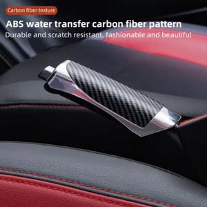 May include: A car interior detail featuring a carbon fiber pattern handbrake lever with a chrome finish. The text reads "ABS water transfer carbon fiber pattern" and "Durable and scratch resistant, fashionable and beautiful."