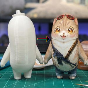 May include: A whimsical figurine of a cat-like character, painted in tan, brown, and blue, wearing sunglasses and a strap with a toy gun. Beside it is a white, unpainted version of the same figure. The figure is approximately 4 inches tall.