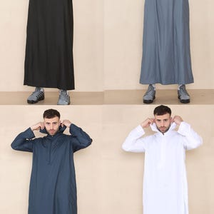 May include: Four full-length hooded robes in black, gray, navy, and white. Each robe has a zipper closure at the neck and long sleeves. The robes are displayed on a neutral background, showcasing the different color options available.