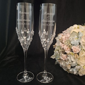 May include: Two clear champagne flutes with engraved names and date. The flutes have a floral design with clear embellishments. The names "Максим & Анастасия" and the date "04.04.2026" are engraved on the glass.