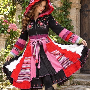 May include: A long-sleeved hooded coat featuring a black bodice with floral embroidery, a front zipper, and a tie waist. The flared skirt and sleeves are constructed from multi-colored, layered knit fabric panels in shades of red, pink, and white.