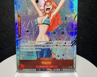 May include: A holographic One Piece trading card featuring the character Nami with orange hair, wearing a striped bikini top and blue jeans, with arms raised. The card includes game text, a power level of 2000, and a counter value of +1000.