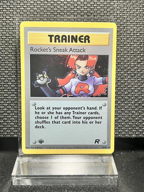 Rocket’s Sneak Attack 16/82 1st Edition Holofoil Proxy Card – Team Rocket Trainer Pokémon Display – BaseSet Era Vintage Collectible