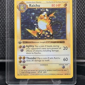 May include: A holographic Raichu Pokémon card, stage 1, with a yellow and orange color scheme. The card features the text "Raichu" and "80 HP". The card is in a protective sleeve. The card's length is 79 cm and weighs 29.9 kg.