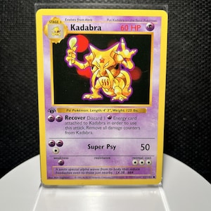 May include: A 1999 Wizards of the Coast Kadabra trading card, Stage 1, 60 HP, featuring a yellow character holding a spoon. The card includes text detailing the Recover and Super Psy attacks, with a 1st Edition stamp and a purple background.