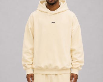 Sudadera con capucha de tejido grueso, 100 % algodón, felpa cepillada de 380 g/m², corte relajado con hombros caídos.